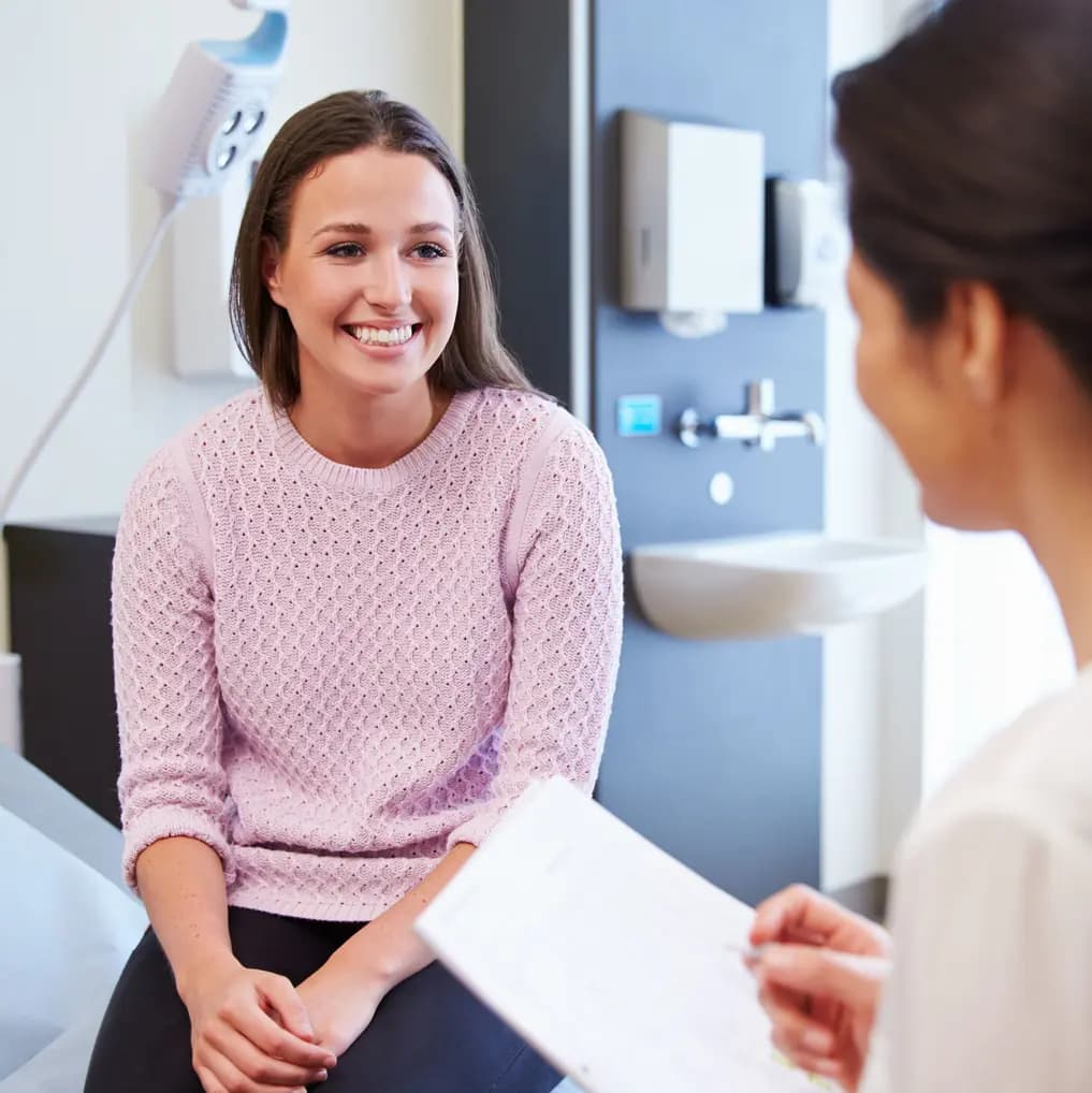 Happy patient talking with doctor